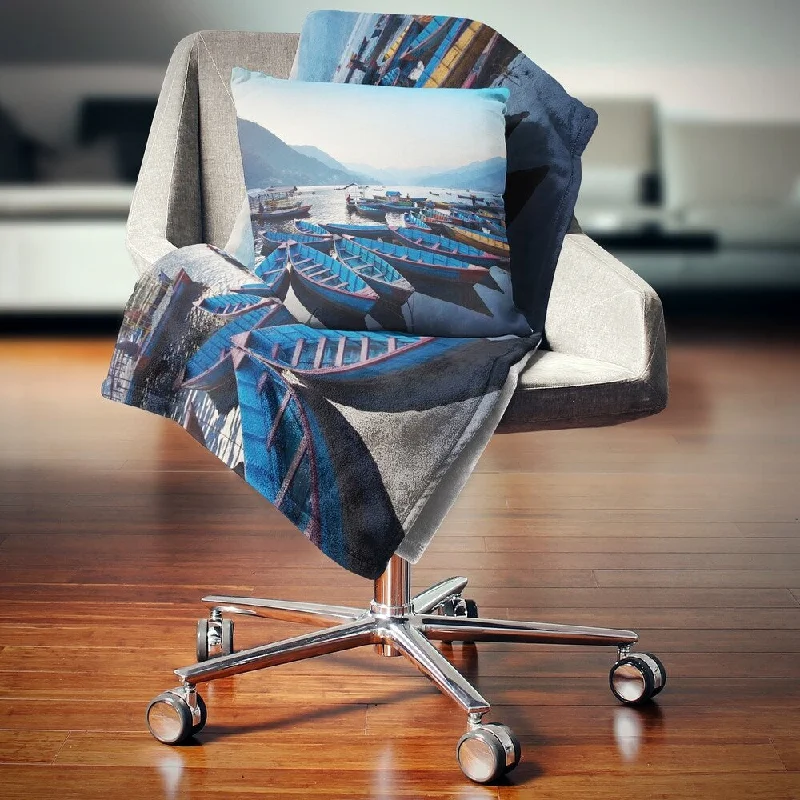 Wool blankets with natural warmth and insulationAcrylic blankets for a soft and affordable alternativeDesignart 'Blue Wooden Boats in Lake' Boat Throw Blanket